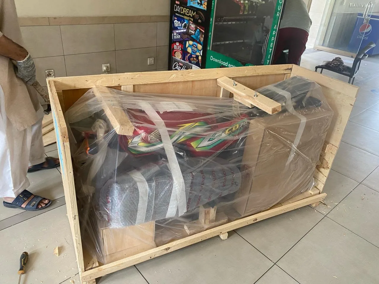 A CD70 motorcycle crated for export at Atlas Honda